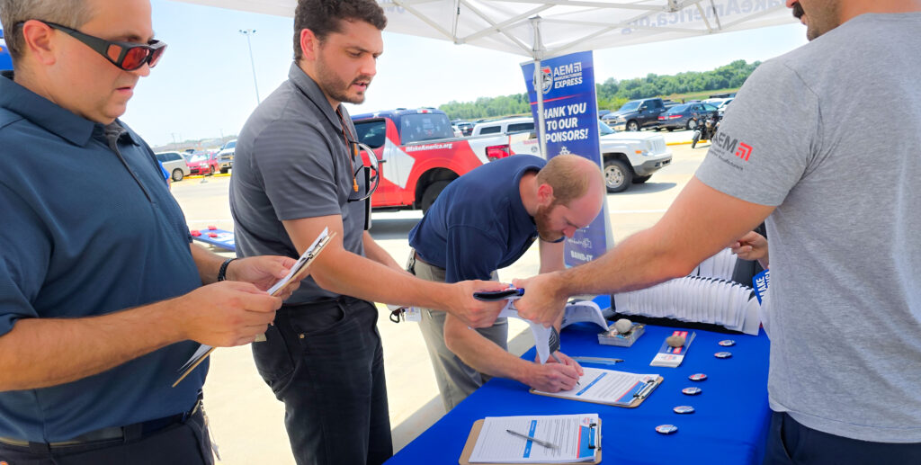 Three men sign the I Make America petition.